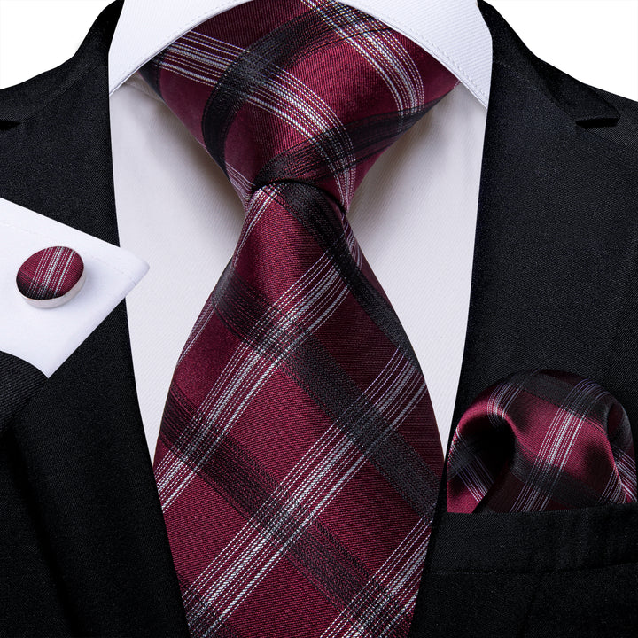 all black suit with burgundy tie